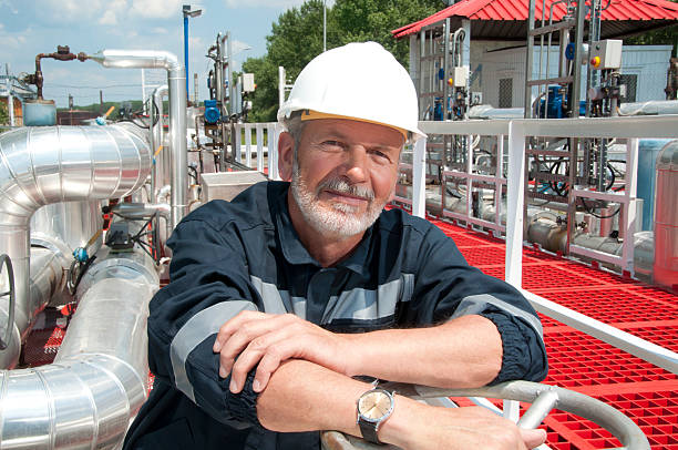 engineer overlooking oil pipeline stock photo