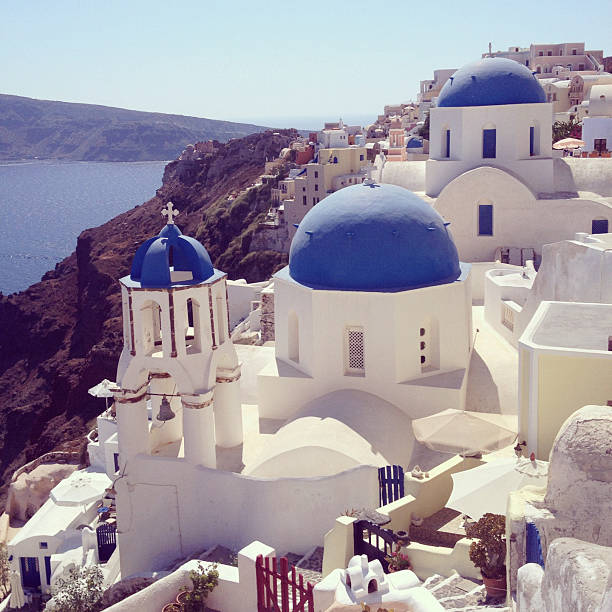 View of Oia town and old castle of Oia, Santorini, Greece. Square toned image, instagram effect
