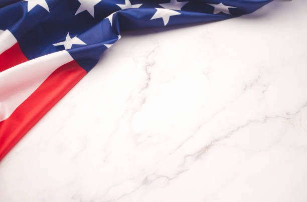 istock Part of the American flag is on a marble table with copy space for text 1749925134