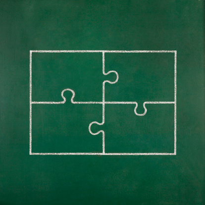 Four pieces of jigsaw puzzle drawn on blackboard