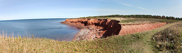 Cavendish Panorama Red sandstone cliffs at Prince Edward Island National Park at Cavendish. Horizontal.-For more Maritime Canada images, click here.  CANADA'S MARITIME PROVINCES  cavendish beach at prince edward island national park canada stock pictures, royalty-free photos & images