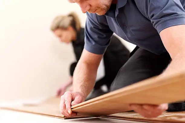 Photo of Construction workers installing new wooden floor