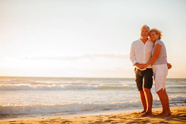 istock Senior couple walking on the beach 174993569
