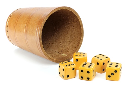 dice cup with five dices on white background