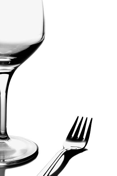 Wineglass And Fork On White Background stock photo