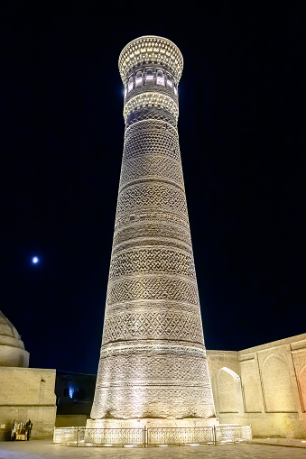 Bukhara, Uzbekistan - August 26, 2023: Mir-i-Arab Madrasa Kalyan minaret and Poi Kalyan Mosque at magnificent night