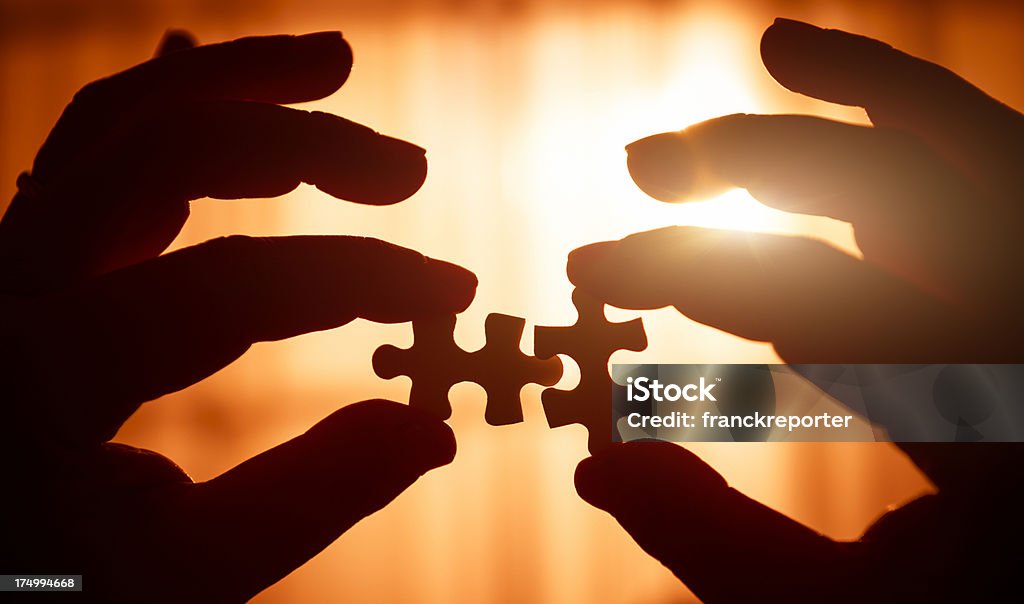 Connecting the piece of puzzle  A Helping Hand Stock Photo