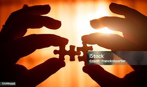 Connecting The Piece Of Puzzle Stock Photo - Download Image Now - A Helping Hand, Achievement, Assistance