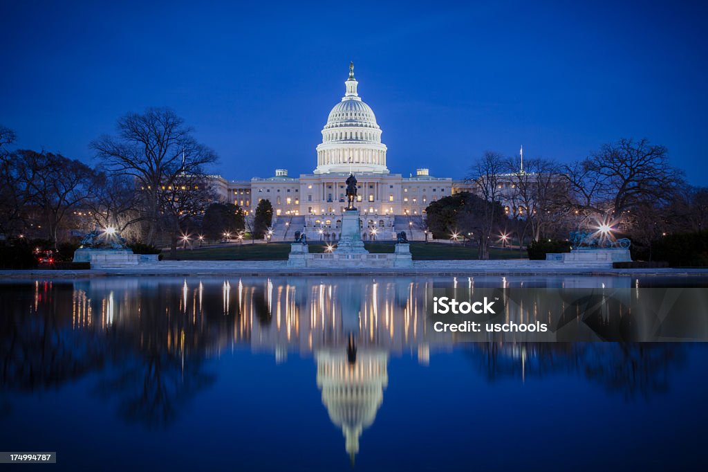 U.S. Capitol at night, with reflection on ice  Capitol Building - Washington DC Stock Photo