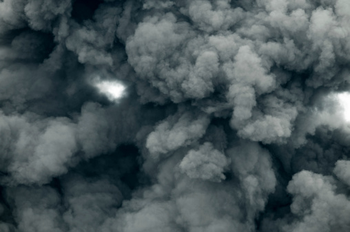 Dark smoke generated by Volcano eruption. Looking straight up.