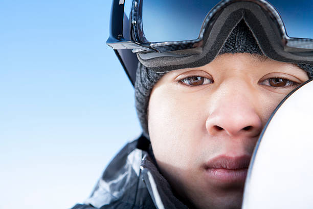 istock Male snowboarder against blue sky 174995063
