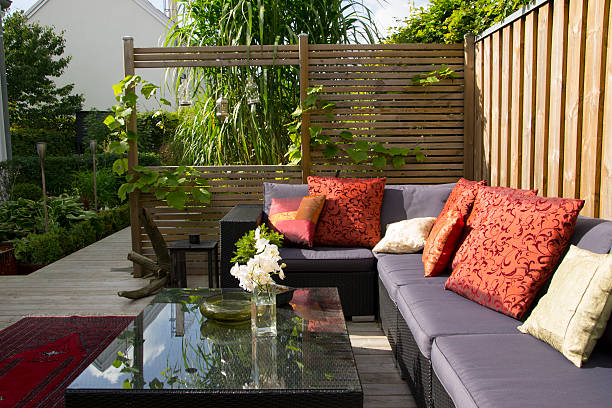 Contemporary patio with large wicker sofa. Garden design A modern patio with an outdoor wicker sofa. trellis photos stock pictures, royalty-free photos & images