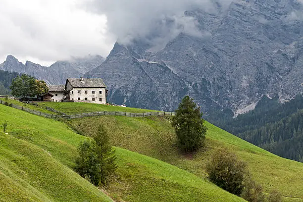 "Old abandoned traditional farmhouse in Wengen in the Val Badia (South Tyrol, Italy). Its located in the little Alpine region Ladinia in the Dolomites. The People in this region speaks Ladin, an old Rhaeto-Romance language. Val Badia has for centuries been characterised by small, compact hamlets, known as Viles, which are spread out regularly along the valley sides used for agriculture."