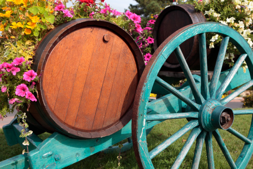 Typical scene in French wine growing village with wine barrel and cart.
