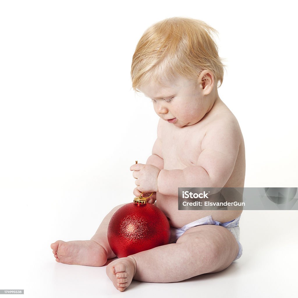 baby playing with Xmas decoration baby in diapers playing with Christmas decoration - for more Xmas 6-11 Months Stock Photo