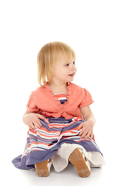 istock Adorable young kid sitting on floor looking at copyspace 174995585