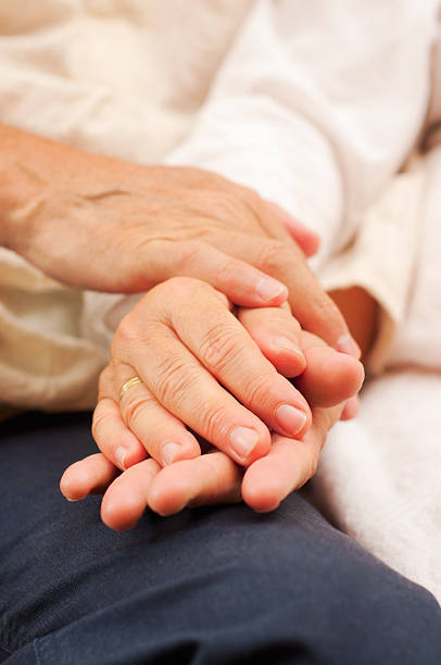 istock Senior couple holding hands 174996423