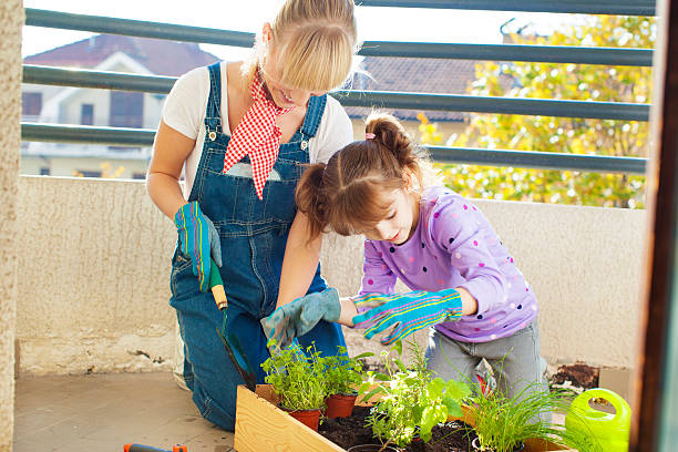 istock Family Planting Herbs at home balcony. 174996547