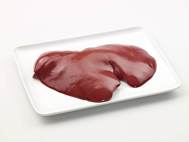 Raw liver in a plate Raw liver in a plate on white background animal liver stock pictures, royalty-free photos & images