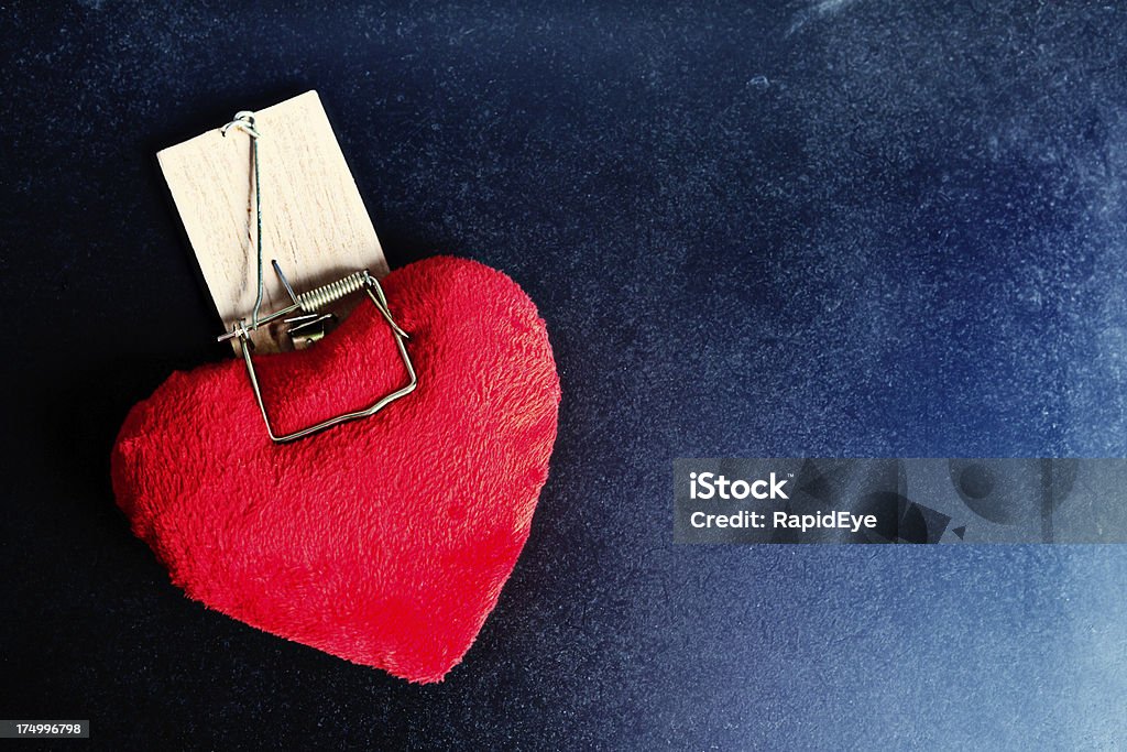 https://media.istockphoto.com/id/174996798/photo/love-hurts-red-valentine-heart-caught-in-jaws-of-mousetrap.jpg?s=1024x1024&w=is&k=20&c=XPdAVpEpEm-PLhl72LcVl-W8T2fvgLptyGwX208IbJA=