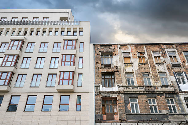 Buildings century apart "Old ruined tenement building next to a modern one. Warsaw, Poland." old style stock pictures, royalty-free photos & images