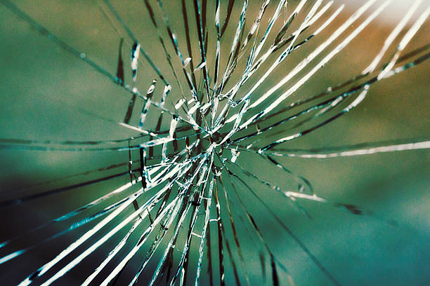 istock Radiating pattern of cracks in shattered window pane glass 174997400