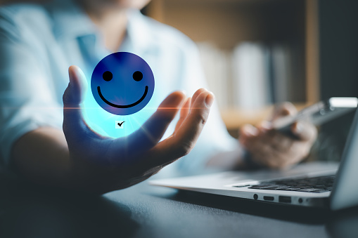 Customer service and Satisfaction concept, Business person are touching the virtual screen on happy Smiley face icon to give satisfaction in service. rating very impressed. customer service feedback.