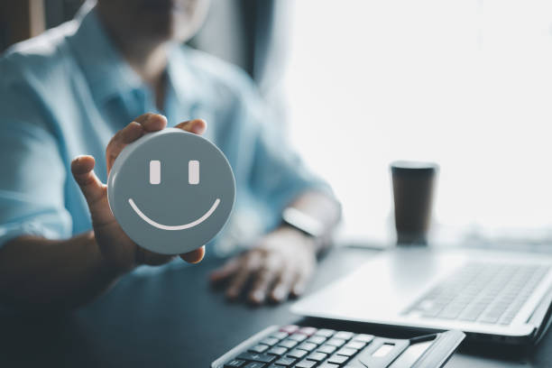 Happy smiley emoticon on a yellow ping pong ball with space for text blue background