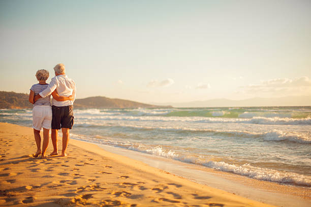 istock Senior couple walking on the beach 174997986