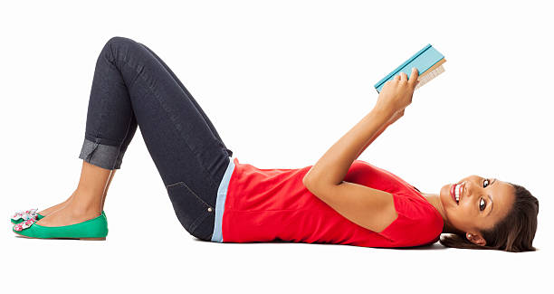 istock Woman Holding Book While Lying On Floor - Isolated 174998112
