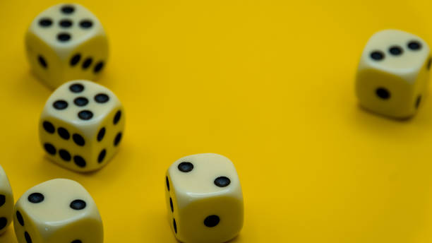 istock messy dice on yellow background, copy space area 1749988642