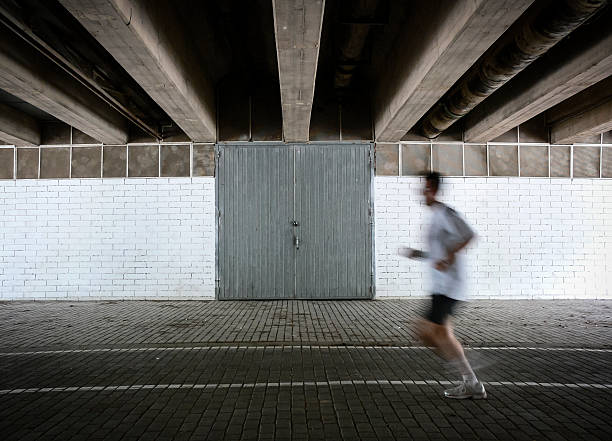 Running An athlete running on an indoor track new york marathon photos stock pictures, royalty-free photos & images