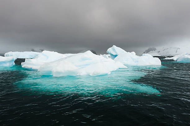 Antarctica Beautiful Iceberg in Antarctic Sea iceberg dramatic sky wintry landscape mountain stock pictures, royalty-free photos & images