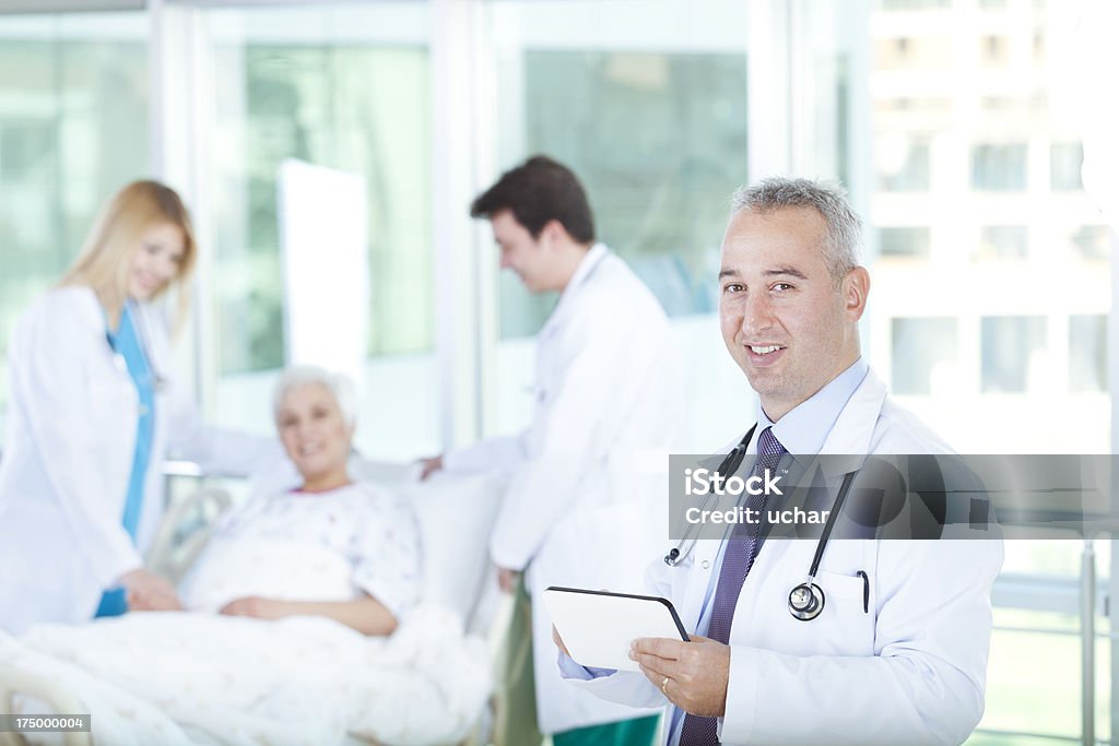 Doctors  Talking Senior Patient Close-up of doctor smiling Accidents and Disasters Stock Photo