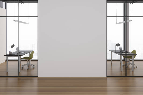istock Stylish office interior with table and chairs, laptop and window. Mock up wall 1750003543
