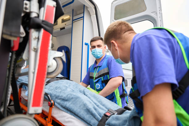 istock Medics in uniform unload a gurney with patient from ambulance 1750005882