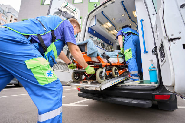 istock Paramedic in a protective mask unloads a patient from an ambulance 1750005884