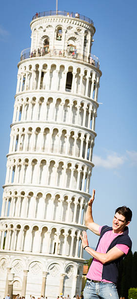 istock tourist holding the leaning tower on Pisa 175000595