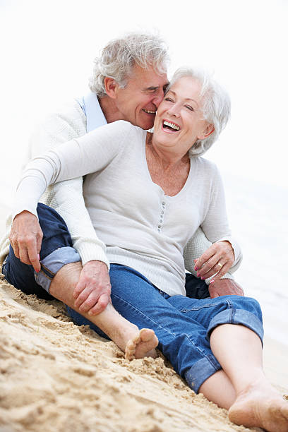 istock Senior Couple Sitting On Beach Together 175000617