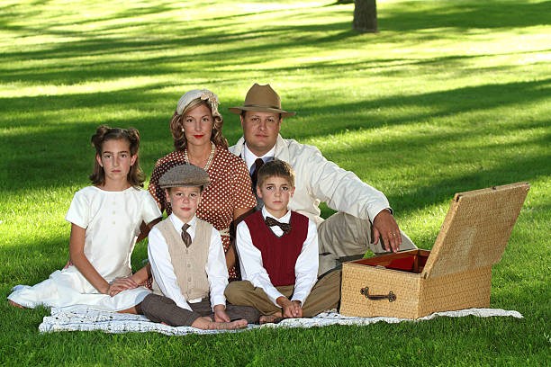 A 1940s family sitting in the grass.