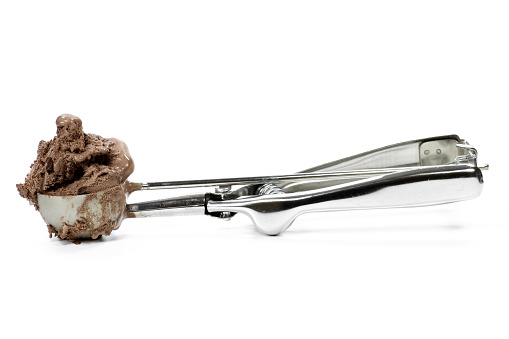 disher scoop with chocolate ice cream isolated on white background