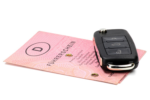 car key with German driving license isolated on white background