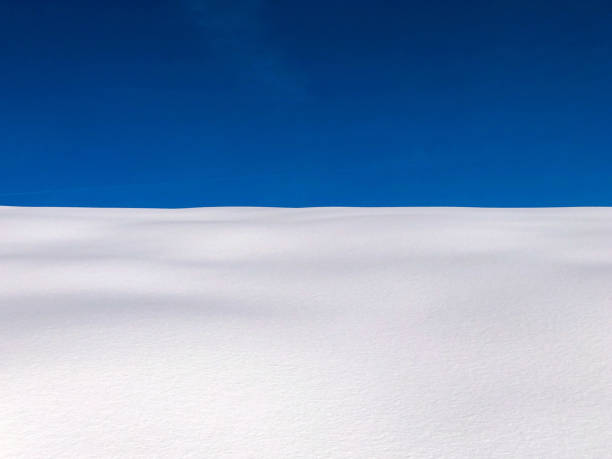 istock Snow covered meadow in the foreground against blue sky 1750027726
