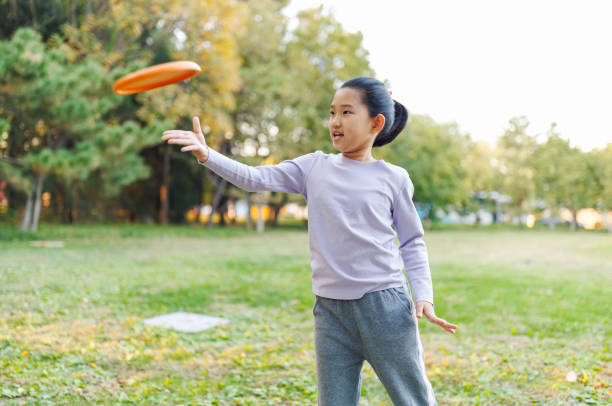 istock Little Girl Playing Frisbee 1750032725