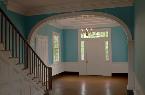 A finely detailed entrance way in a Colonial era home. Beautiful Federal style blue paint on the walls.