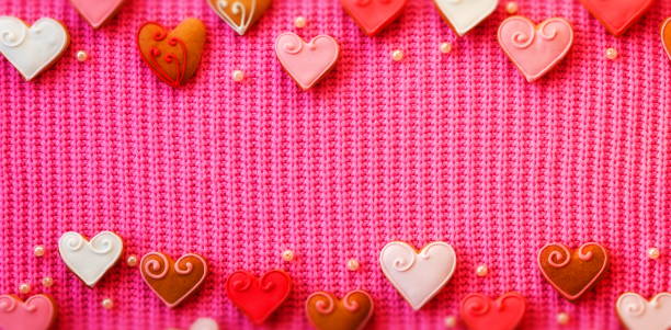 istock Pink Banner Hearts Cookies Top And Bottom with Copyspace. Wide Wallpaper 1750043721