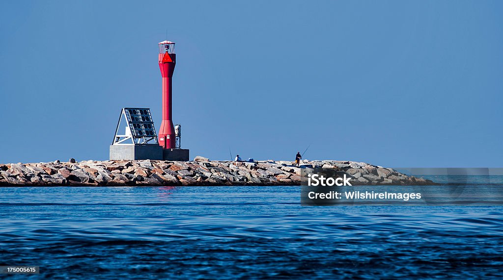 Cape Cod Canal Lighthouse on Breakwater Cape Cod Canal lighthouse and solar panel on breakwater at entrance from Cape Cod Bay. Some people say the red fiberglass lighthouse looks like a dumbbell. Canal Stock Photo