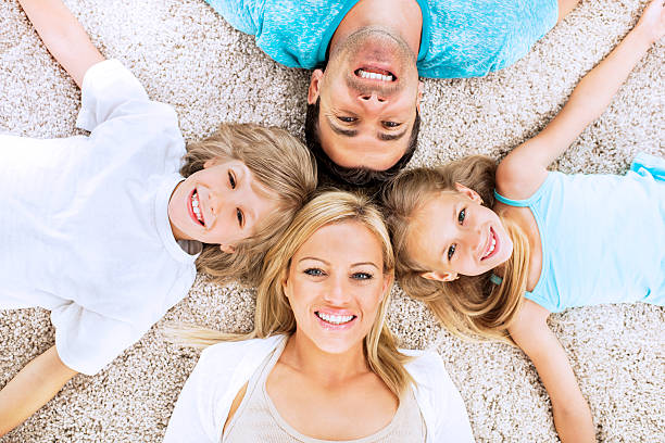 família divertida. - couple loving lying on back carpet imagens e fotografias de stock