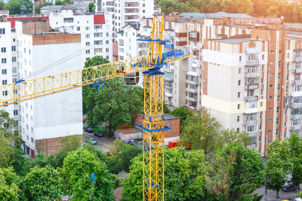 istock Crane and building under construction against blue sky 1750076040