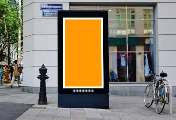 blank billboard lightbox ad along sidewalk. outdoor advertising mock-up sign panel blank billboard lightbox ad sign along sidewalk. outdoor advertising sign panel. parked cars. pedestrians walking by. outdoor advertising poster. mock-up base. business communication template and placeholder. bus shelter stock pictures, royalty-free photos & images